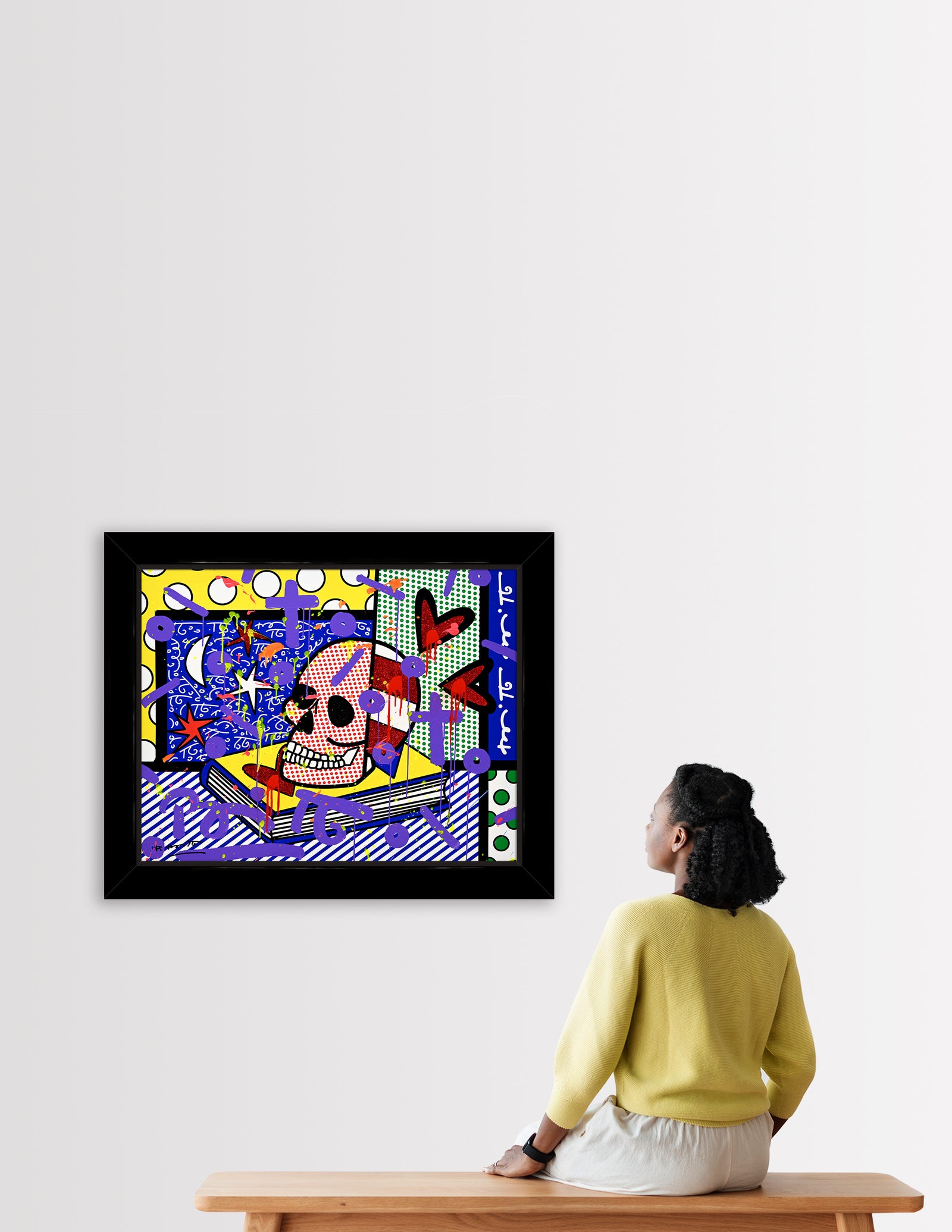 This image is a colorful, abstract artwork featuring a red and white skull on an open book. The background includes various patterns like polka dots, stripes, stars and crescent elements. Bright colors such as yellow, blue, green, and purple are used, with additional shapes and paint splashes adding a dynamic touch. mixed media original Romero Britto art Pop Art Skull art